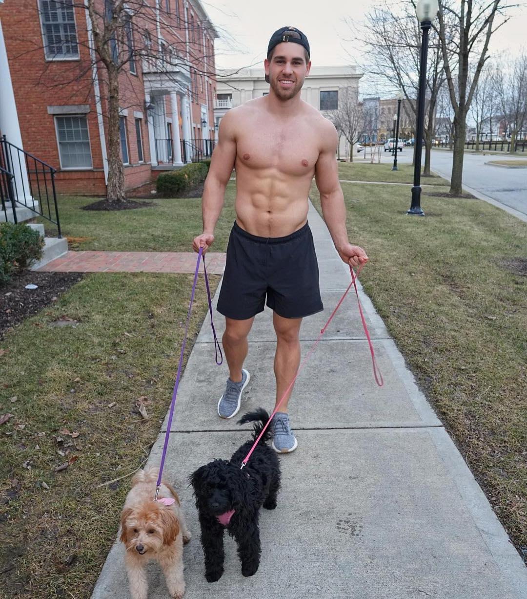 cute-smiling-happy-dude-shirtless-fit-body-dog-walker-street