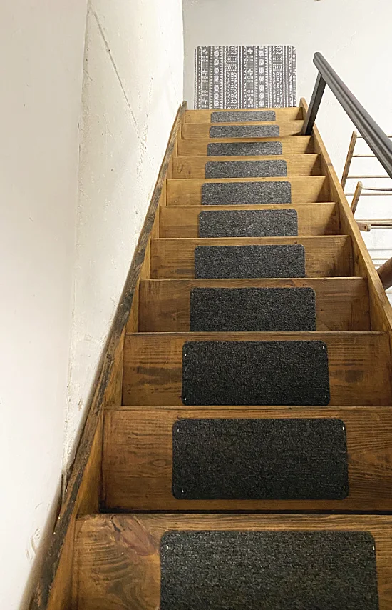 stained and painted steps with rugs