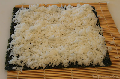 Sushi rice put on seaweed sheets