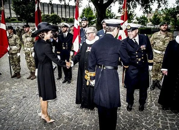 Prince Frederik and Crown Princess Mary at wreath-laying ceremony Prada Cappotto black coat. Gianvito Rossi Pumps, Hugo Boss clutch