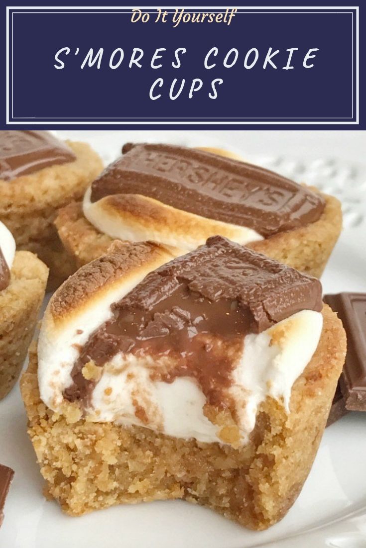 S'mores Cookie Cups | S'mores | S'mores cookie cups are baked in a mini muffin pan. Graham cracker cookie base, with a toasted marshmallow, and a piece of gooey chocolate on top! Now you can enjoy campfire toasty s'more all year round for dessert. S'mores Cookie Cups | S'mores | S'mores cookie cups are baked in a mini muffin pan. Graham cracker cookie base, with a toasted marshmallow, and a piece of gooey chocolate on top! Now you can enjoy campfire toasty s'more all year round for dessert.