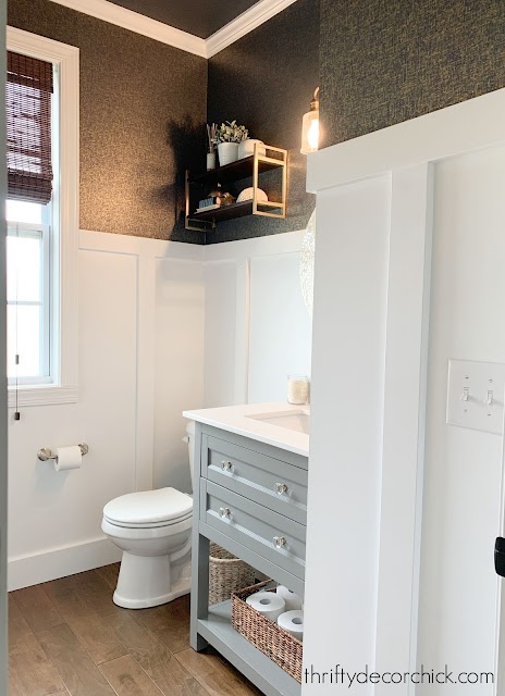 white board and batten bathroom with dark wallpaper