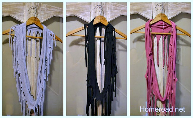 Row of fringed scarves on hangers
