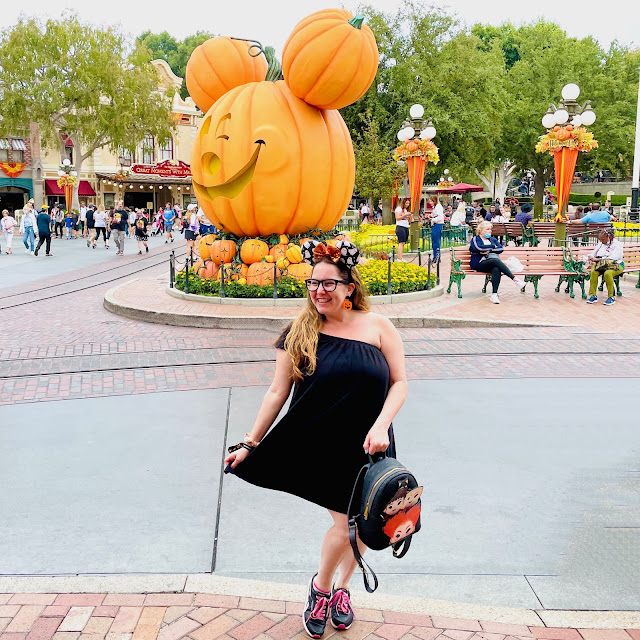 Jamie Allison Sanders is showing off her Halloween Spooky Season looks at the Mickey pumpkin in Disneyland with a Loungefly Hocus Pocus backpack.