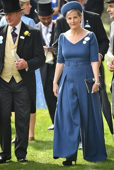 The Countess of Wessex wore a  wide-leg jumpsuit by Emilia Wickstead. Princess Eugenie wore a belted silk satin midi dress by Cefinn