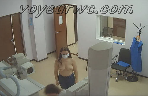 Spy camera catches woman taking off her bra to view thorax on the X-ray apparatus (X-ray Examination 01-09)