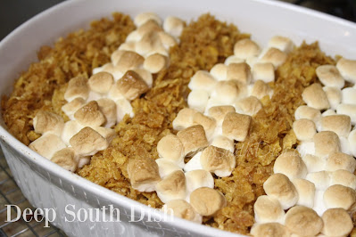 A shortcut sweet potato casserole with the unusual addition of banana and finished with rows of marshmallows and brown sugar sweetened cornflake cereal crumbs.