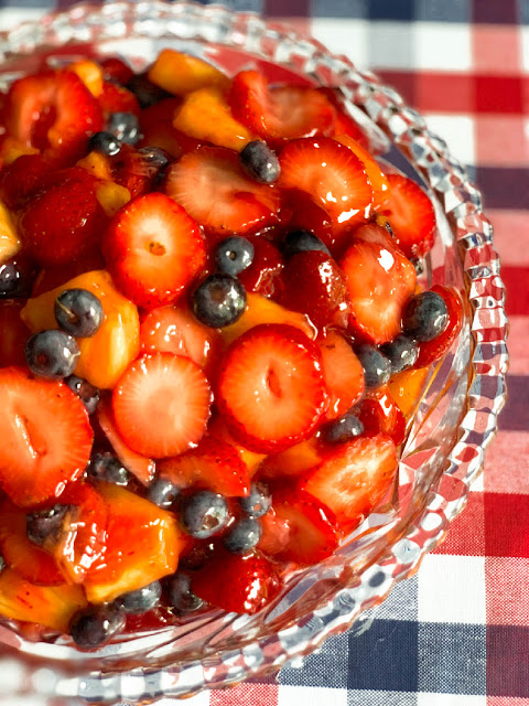 A photo of Stain Glass Fruit Salad served in a clear cut glass serving bowl - by Cooking with K