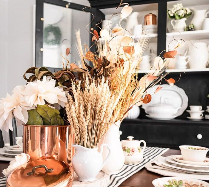 fall wheat, florals and dried foliage on decorated table