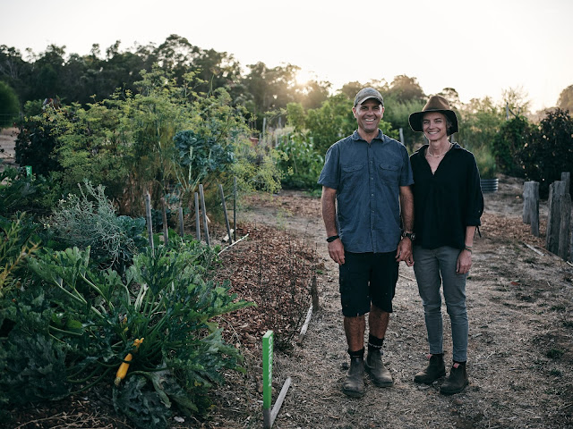 Photo of Cree Monaghan and Tim Hall on in the farm surrounded by foliage