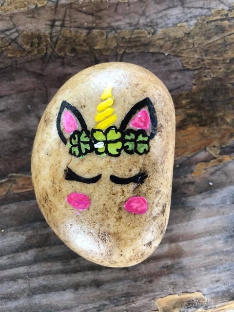 unicorn painted rock with a shamrock crown