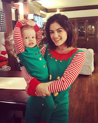 Lucy Hale wearing matching elf Christmas pajamas