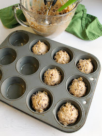 oatmeal and chocolate chip sourdough muffin batter scooped into muffin pan