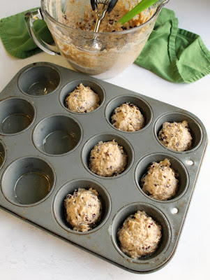 oatmeal and chocolate chip sourdough muffin batter scooped into muffin pan