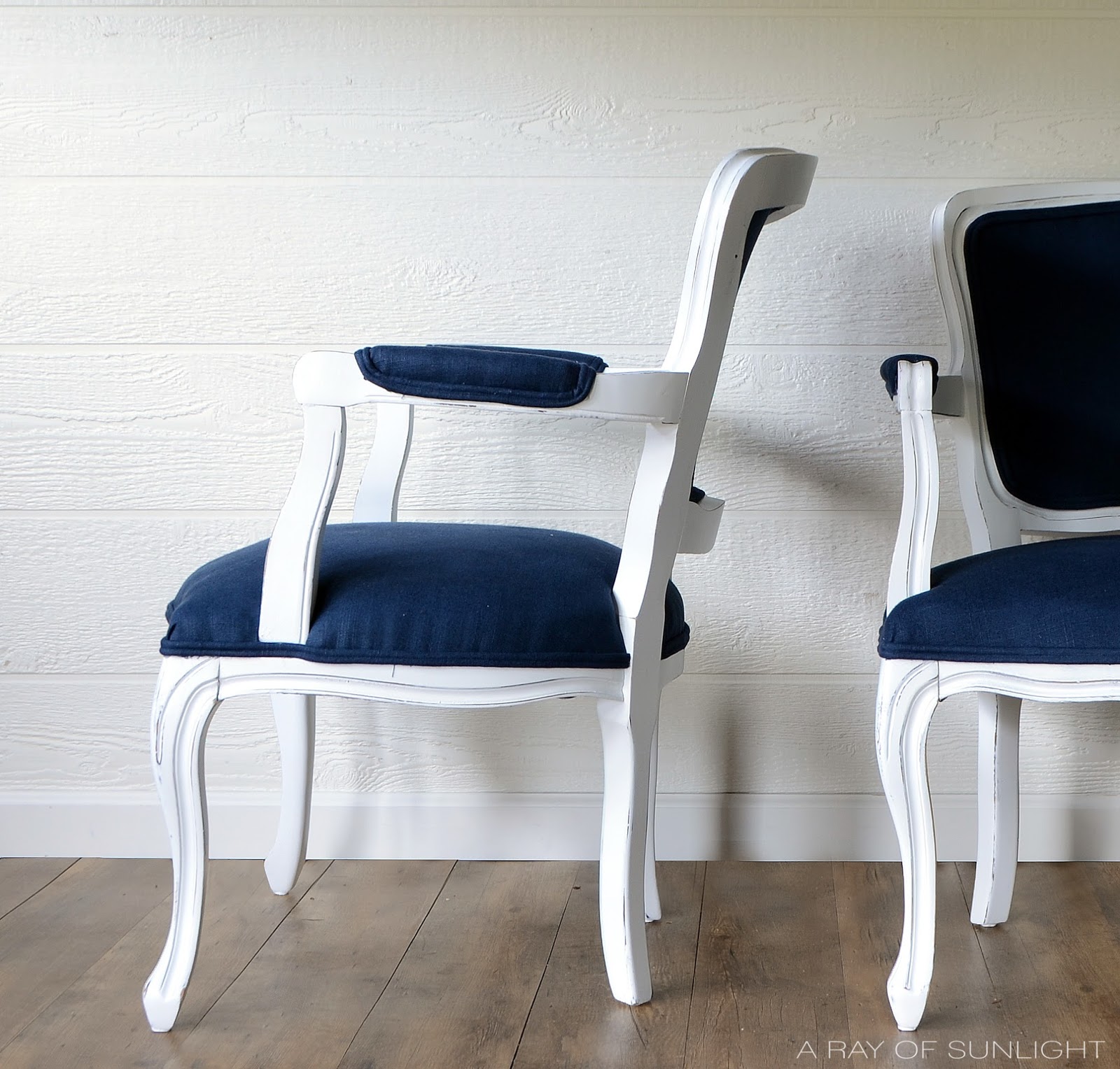 How to easily update old worn out thrift store chairs with some paint and fabric by A Ray of Sunlight Furniture. Love the navy blue and white makeover!