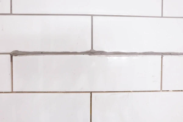 using a grout bag to fill tile joints