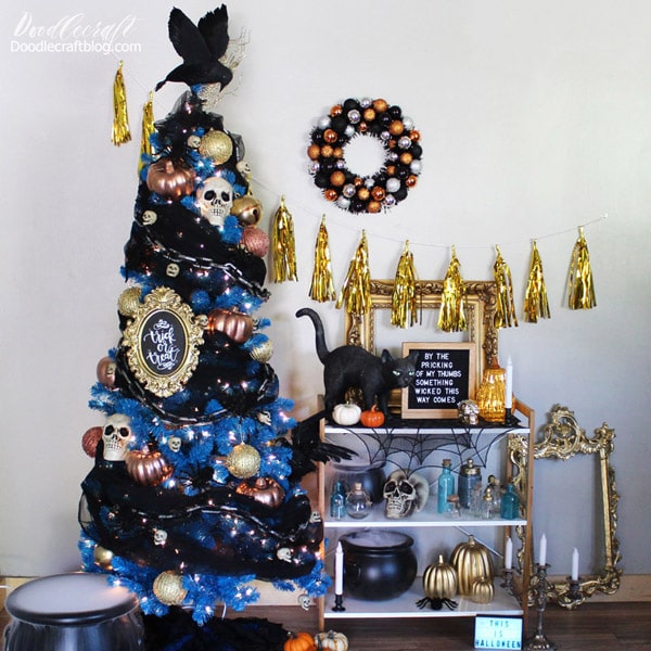 Make a haunted display in your home with a bright blue Christmas tree decorated with spooky skulls, pumpkins, chains and topped with black crows for the perfect Halloween tree.