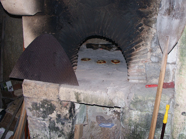Pizzas cooking in an old bread oven in a troglodyte cave, Indre et Loire, France. Photo by Loire Valley Time Travel.