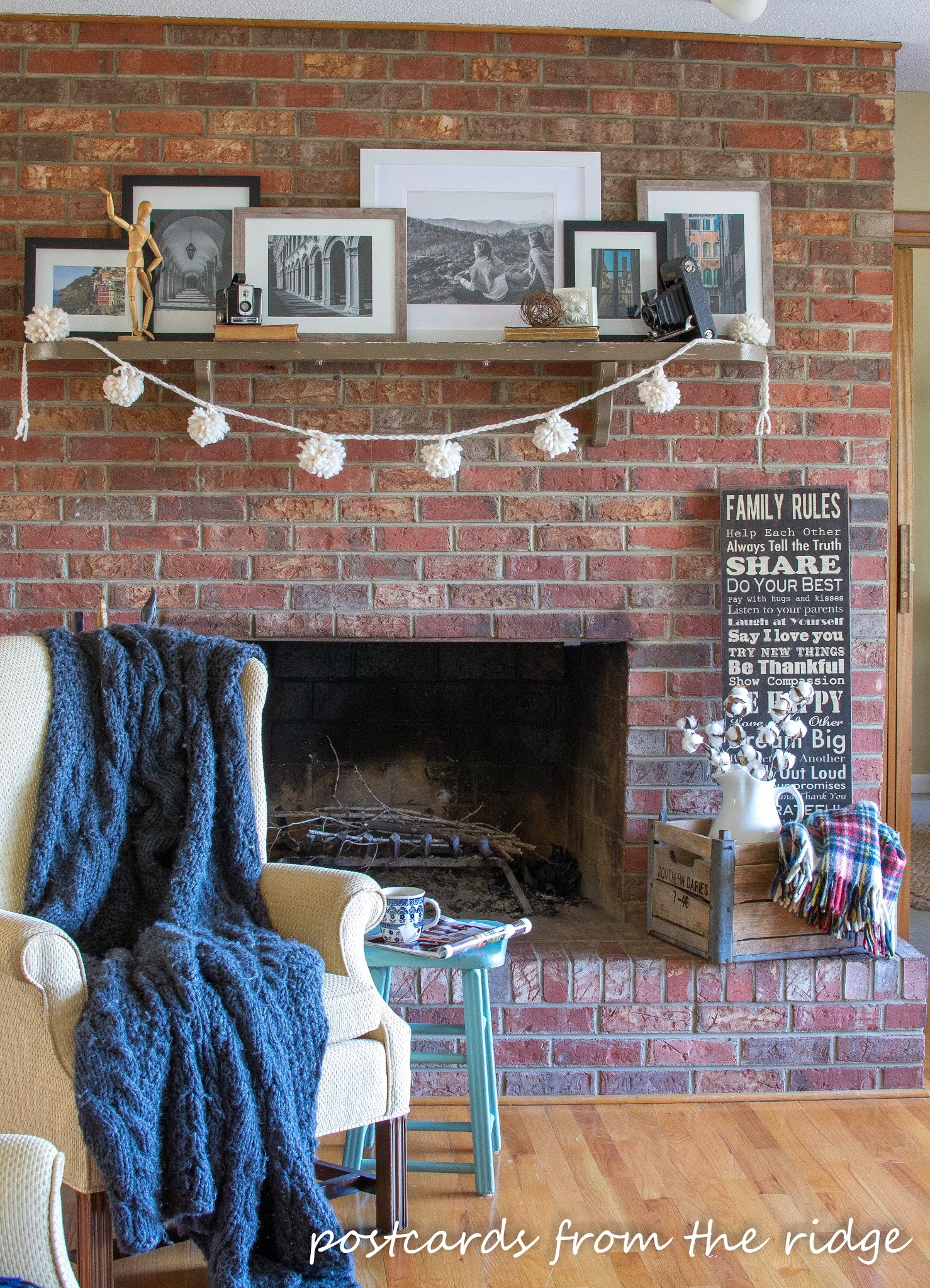 brick fireplace with yarn pom poms