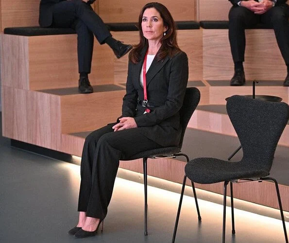 Healthcare Denmark. dark grey pinstripe belted blazer, pinstripe blazer pants suit. Crown Princess Mary wore a drop earrings from Marianne Dulong