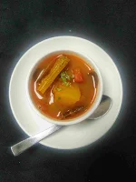 Serving hot sambar in a bowl for medu vada