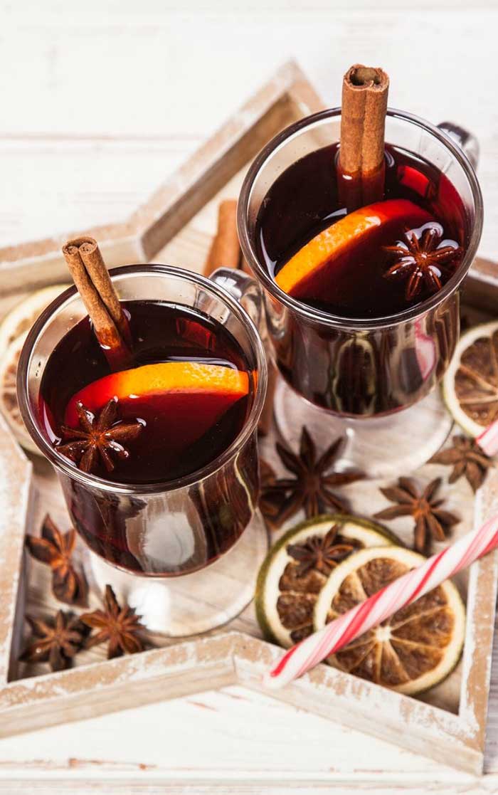 How to make mulled wine in a Crockpot slow cooker. The easy recipe can be made with brandy or without. Make it sugar free with maple syrup or honey so it's still sweet. This classic fall drink is also good for Thanksgiving or Christmas for the holiday season. Use mulling spices or a mix of dried spices for the best simple mulled wine recipe. #mulledwine #drink #wine #recipe