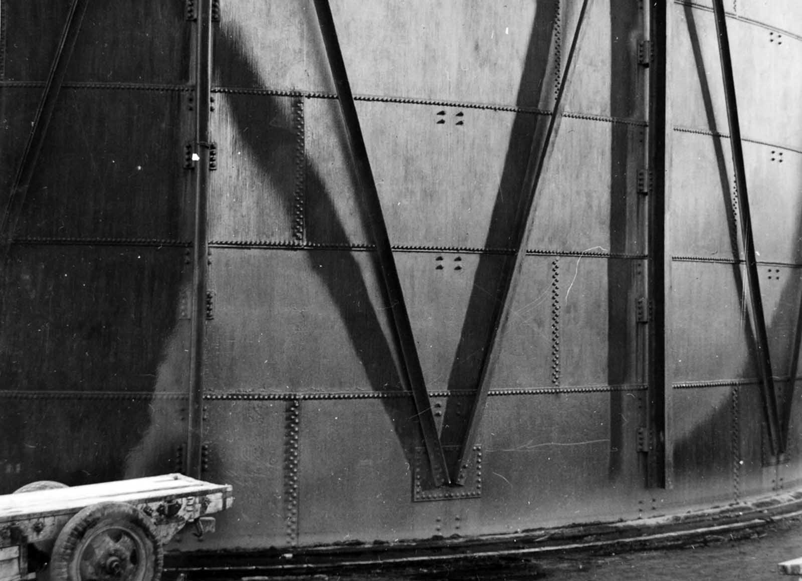 In Hiroshima, gas tanks showing shadowing effects of the flash on asphalt paint.