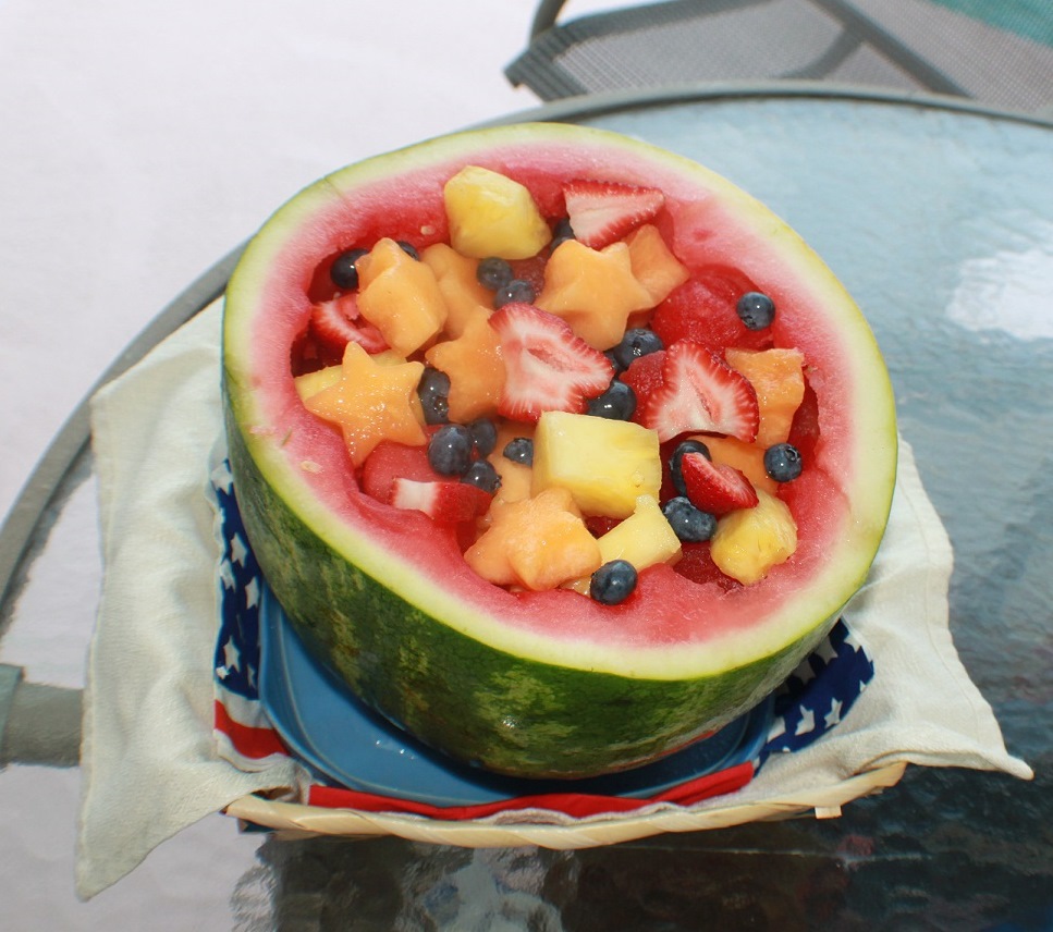 Watermelon carved out and filled with various cookie cutter shaped images for a festive 4th of July Fruit Bowl