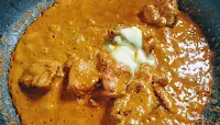Mixing butter with chicken gravy for butter chicken Murgh makhani recipe