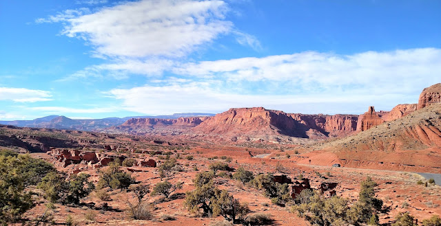 A wide landscape of mountains, desert, and rocks.