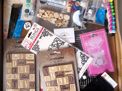 A range of paper supplies strewn in a box.