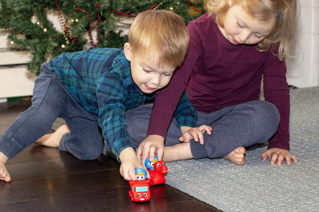 Morphle mini vehicle toys with Mila sitting on them being played with by siblings