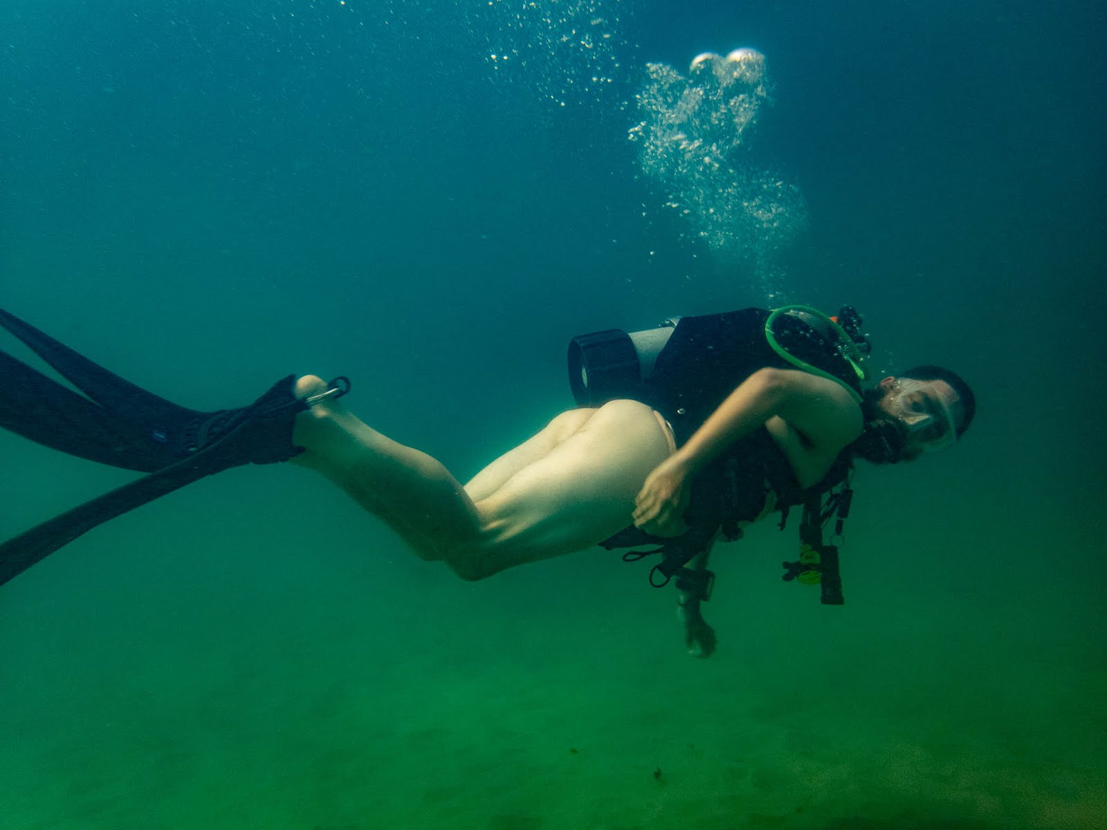 Naked male diving