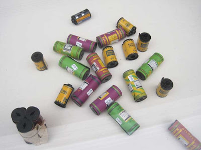 Multi-colored film canisters casually arrayed in a case