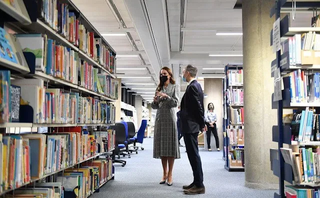 Kate Middleton wore a houndstooth dress by Zara, and Hugo Boss pumps and Mappin and Webb diamond earrings