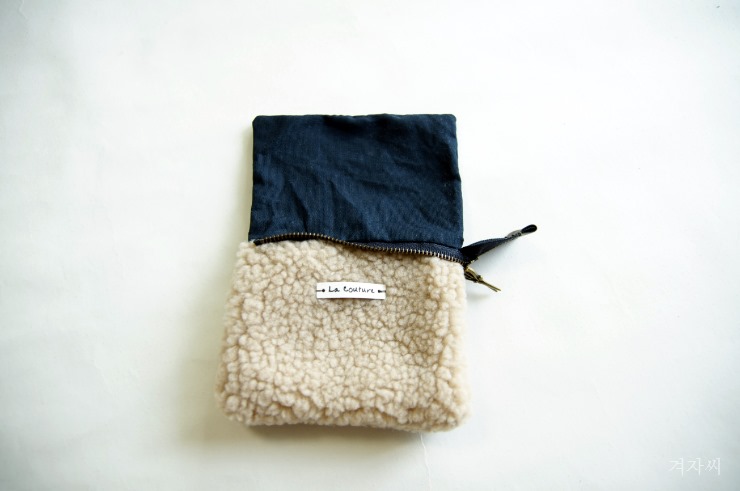 Small cosmetic pouch made of faux fur makeup bag mini wallet. Small cosmetic pouch made of faux fur makeup bag mini wallet.