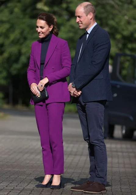 Kate Middleton wore a purple suit by Emilia Wickstead. Emmy London Josie pumps and Jaeger quilted bag