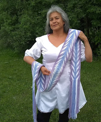 Artist Marilyn Isaacs with a lilac and lavender sash she made