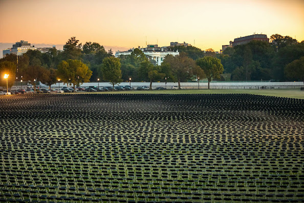 Photo of a memorial for Covid dead, showing the lawn of the national mall covered with chairs