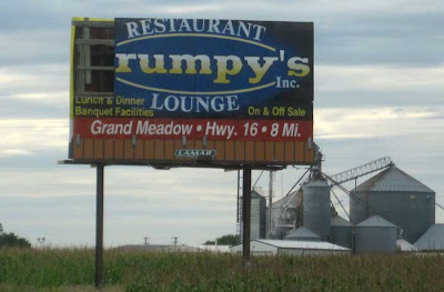 Billboard missing its first panel so that it reads RUMPY'S LOUNGE