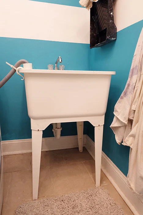 white plastic laundry utility tub sink before