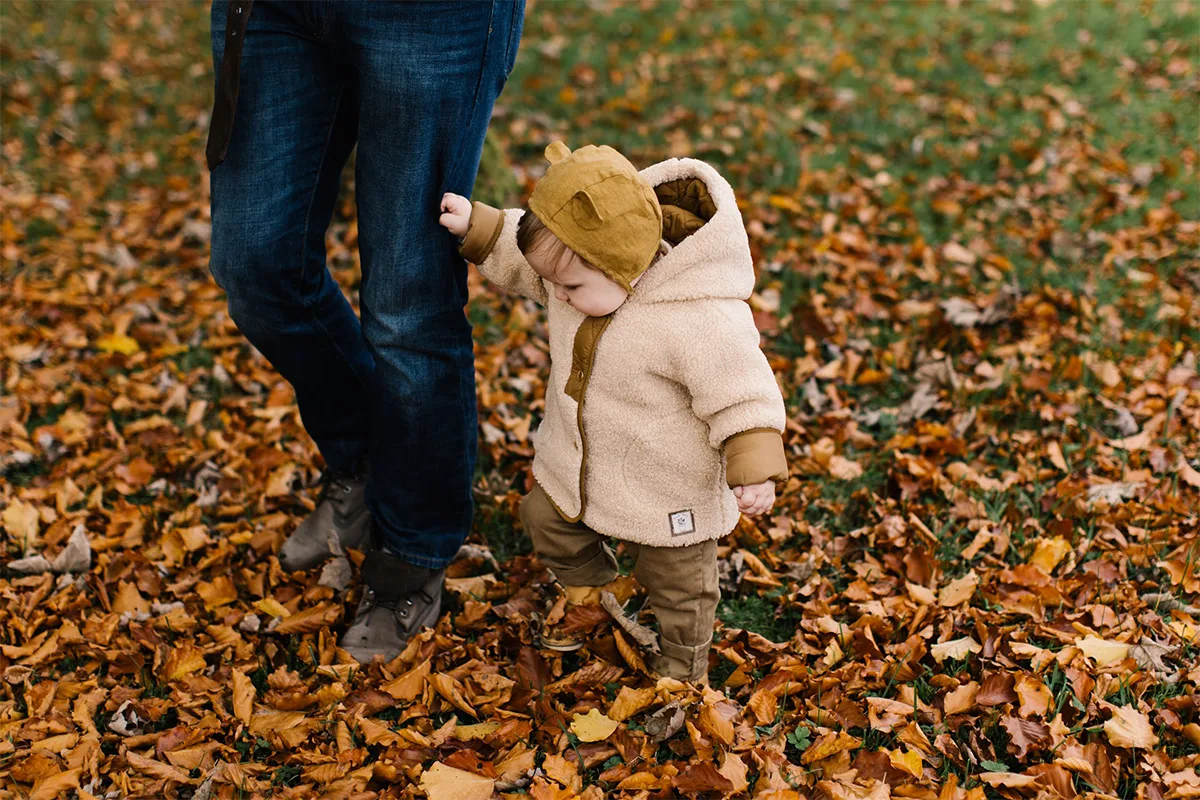 toddler in the autumn forest in a coat