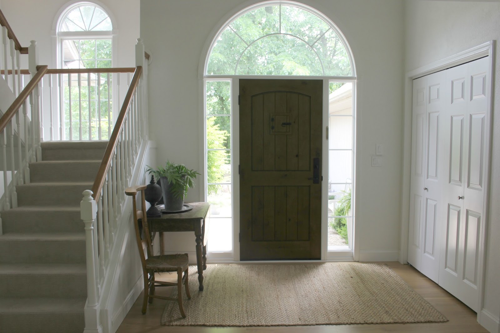 Spare and simple Belgian style and European country mood in an entry with a walnut stained alder front door. Come be inspired on Hello Lovely by 7 Low Cost Timeless Decorating Ideas That Don't Involve the Dollar Store As Well As Photos Around My House.