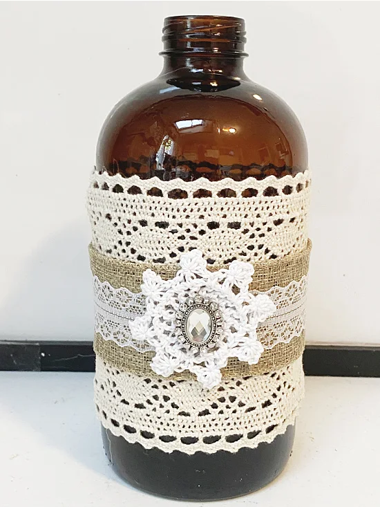 Amber bottle wrapped with lace and bling