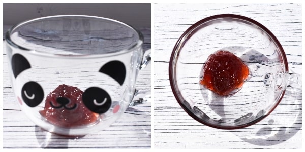 Making Microwave Jam Sponge Pudding - Step 4 - Jam in clear glass mug with panda face