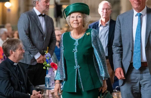 The Princess wore a green embroidered skirt suit, embroidered cape and green hat, gold brooch