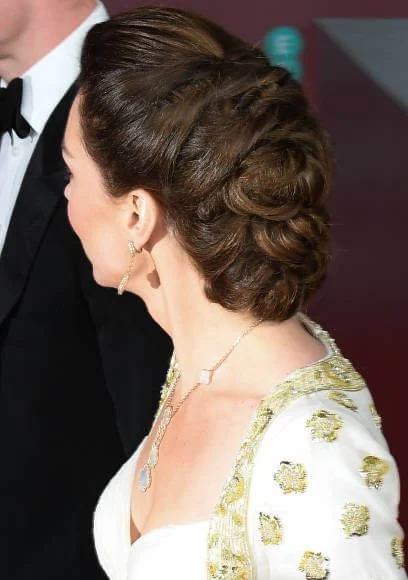 The Duchess wore a gown by Alexander McQueen. Jimmy Choo Romy gold pumps, She carries Anya Hindmarch gold glitter box clutch