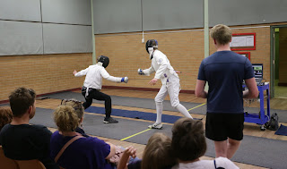 image of fencers being watched by a crowd