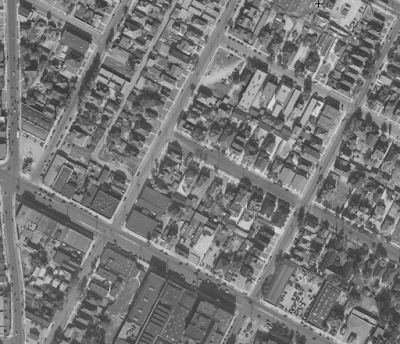 A black-and-white aerial photograph of city streets.