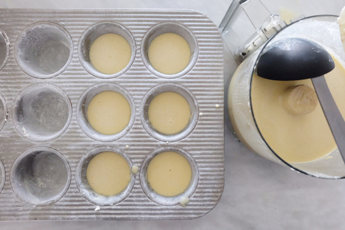 filling muffin tin with batter